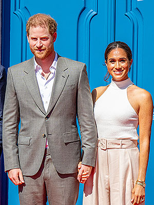 Prince-Harry-Meghan-Markle-hold-hands-spl-vert.jpg