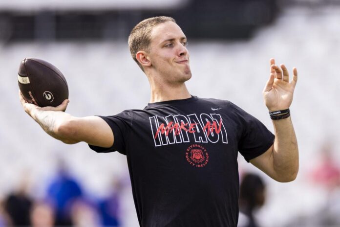 Carson-Beck-15-of-the-Georgia-Bulldogs-warms-up-before-the-start-of-a-game-against-the-Florida-Gators-e1699050050303.jpg