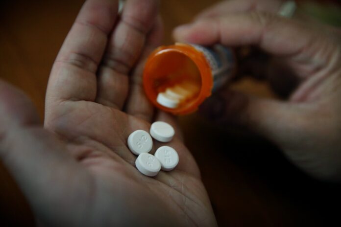 getty-pills-bottle-hand.jpg